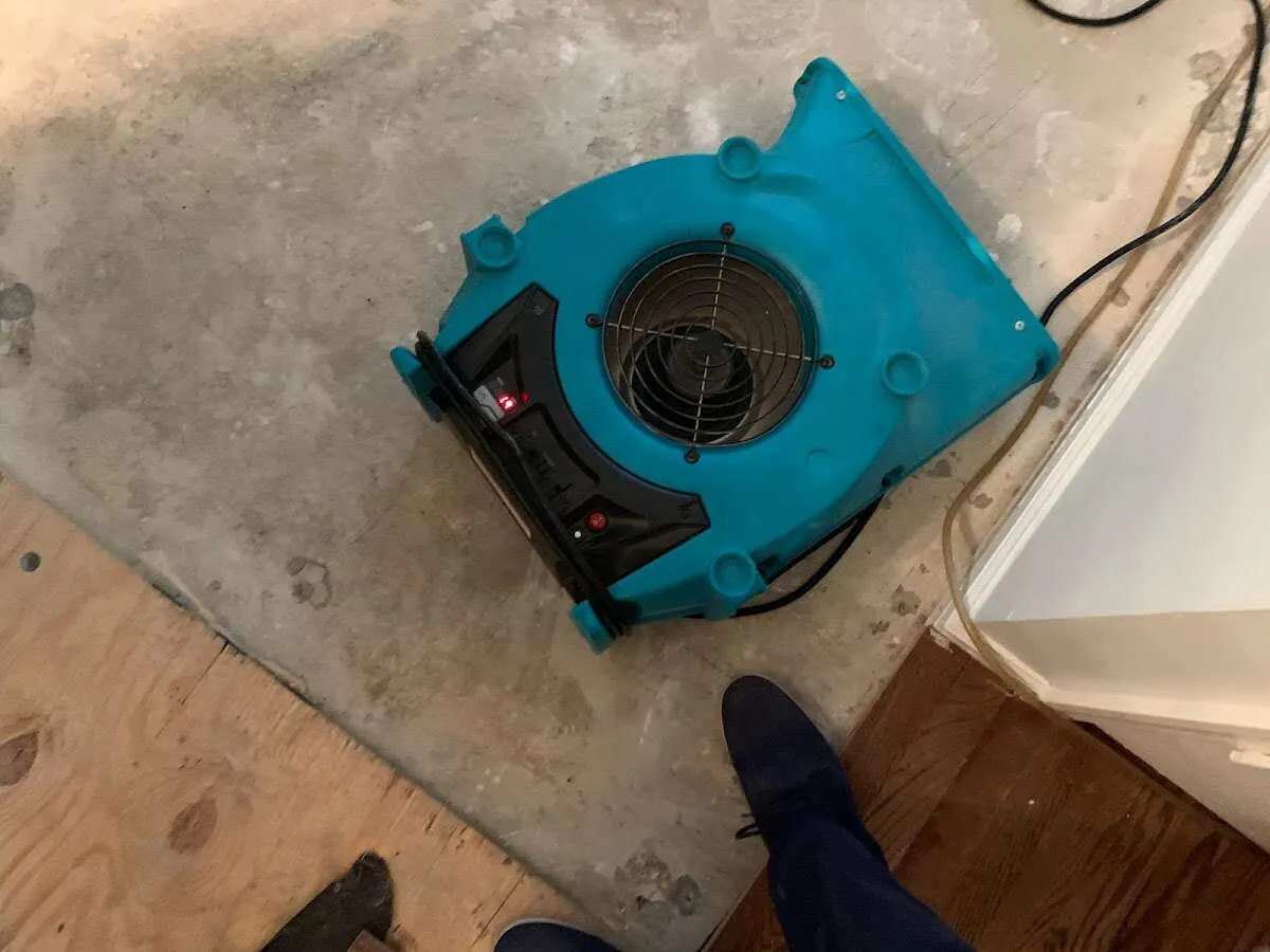 Air mover drying subfloor during Leak Detection & Repair in Bangor Base